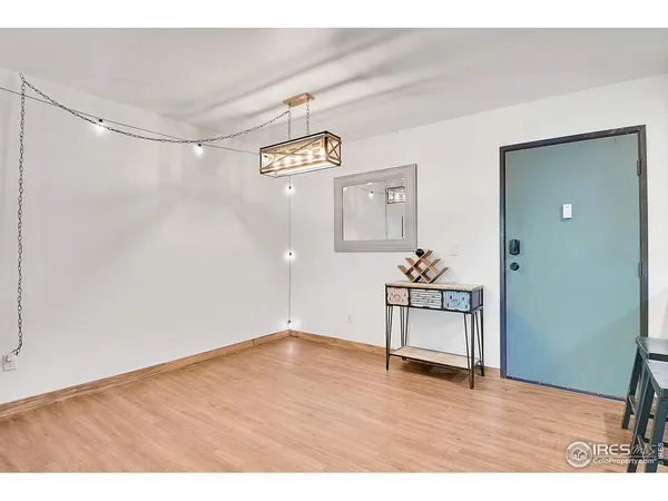 a view of a room with wooden floor