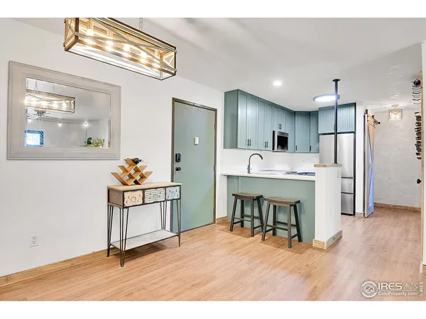 a kitchen with stainless steel appliances kitchen island hardwood floor and cabinets
