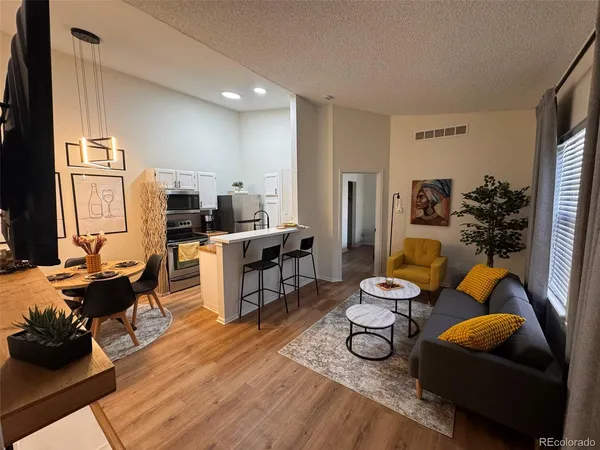 a living room with furniture flat screen tv and large window