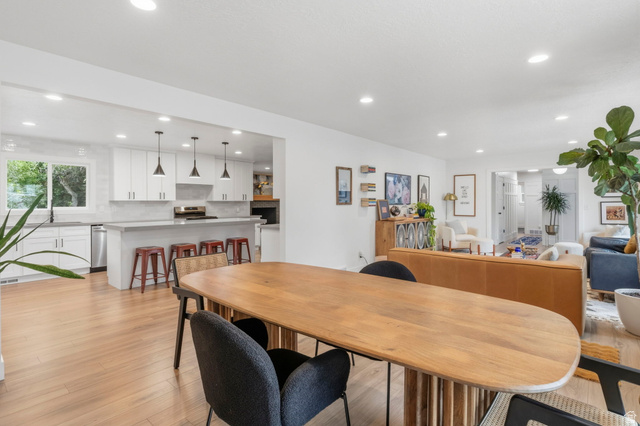 4150 Dover Lane Provo, UT 84604 - Photo 10 of 44 Open-concept living space featuring wood-finish flooring, recessed lighting, and a kitchen with white cabinetry