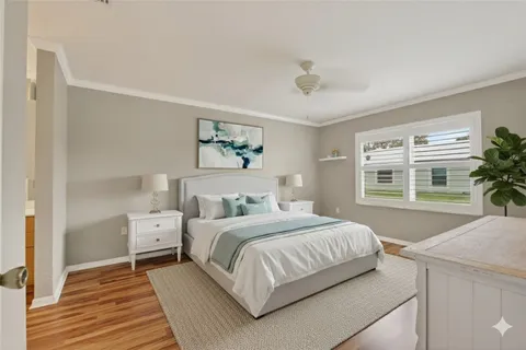 a bedroom with a large bed and a potted plant