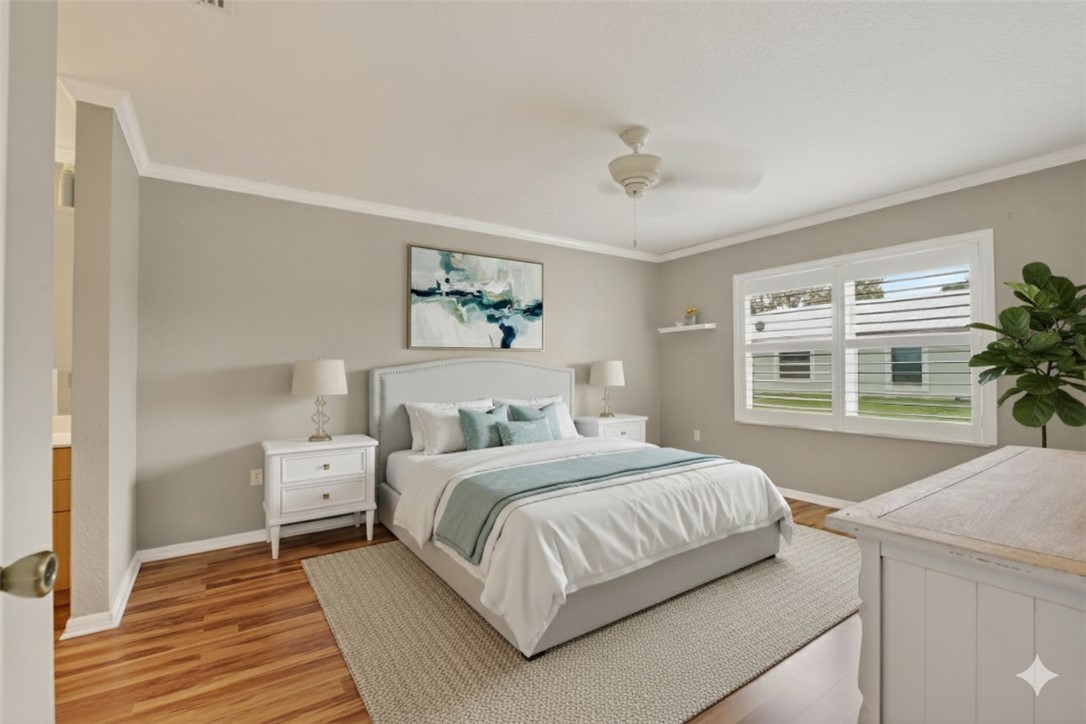 14339 Amapola Circle Fort Pierce, FL 34951 - Photo 14 of 36 a bedroom with a large bed and a potted plant