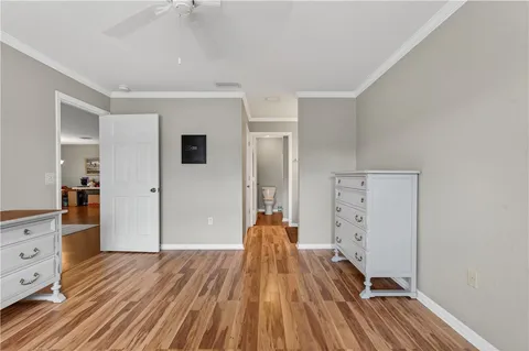 a view of a bedroom with wooden floor