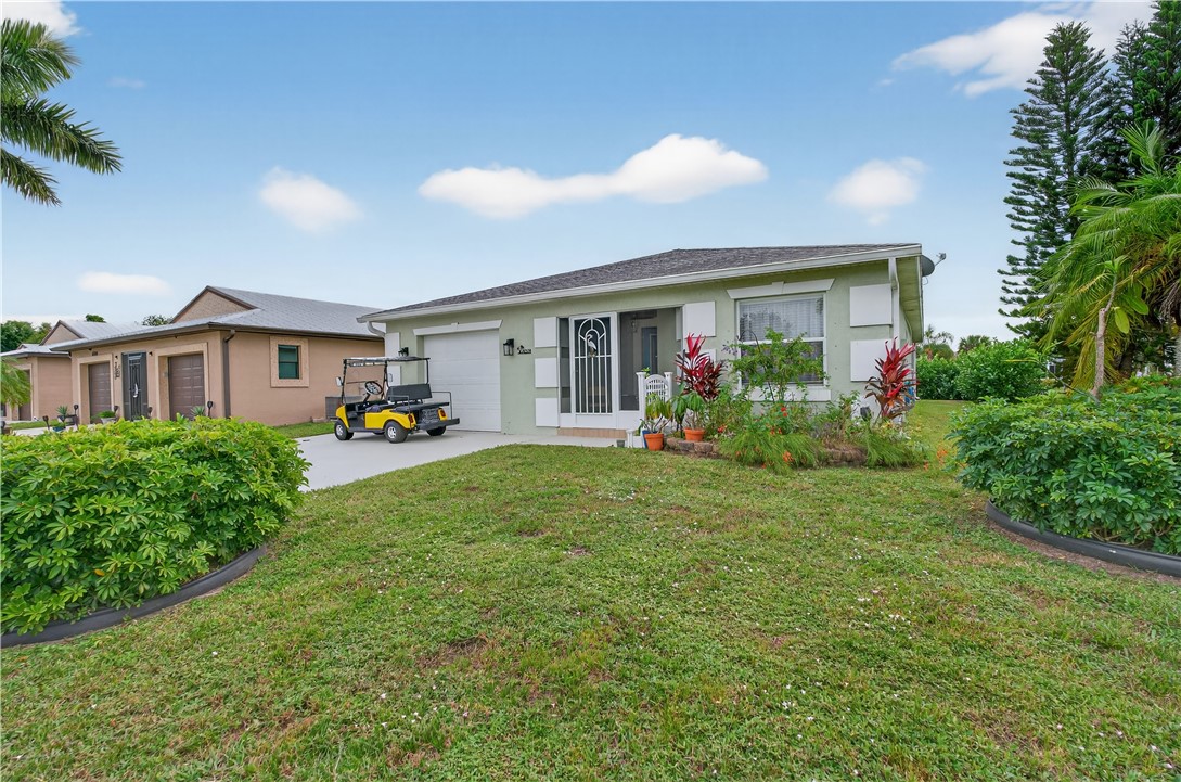 14339 Amapola Circle Fort Pierce, FL 34951 - Photo 26 of 36 a front view of house with yard and outdoor seating