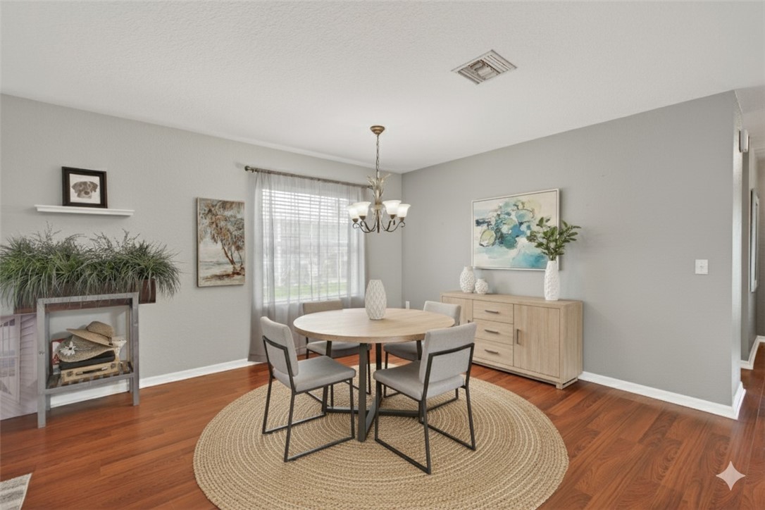 14339 Amapola Circle Fort Pierce, FL 34951 - Photo 3 of 36 a dining room with furniture wooden floor a chandelier and a rug