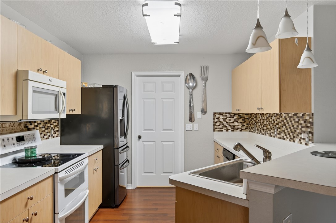 14339 Amapola Circle Fort Pierce, FL 34951 - Photo 7 of 36 a kitchen with a refrigerator stove and sink