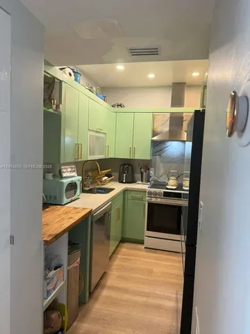 a large kitchen with stainless steel appliances granite countertop a sink and stove top oven