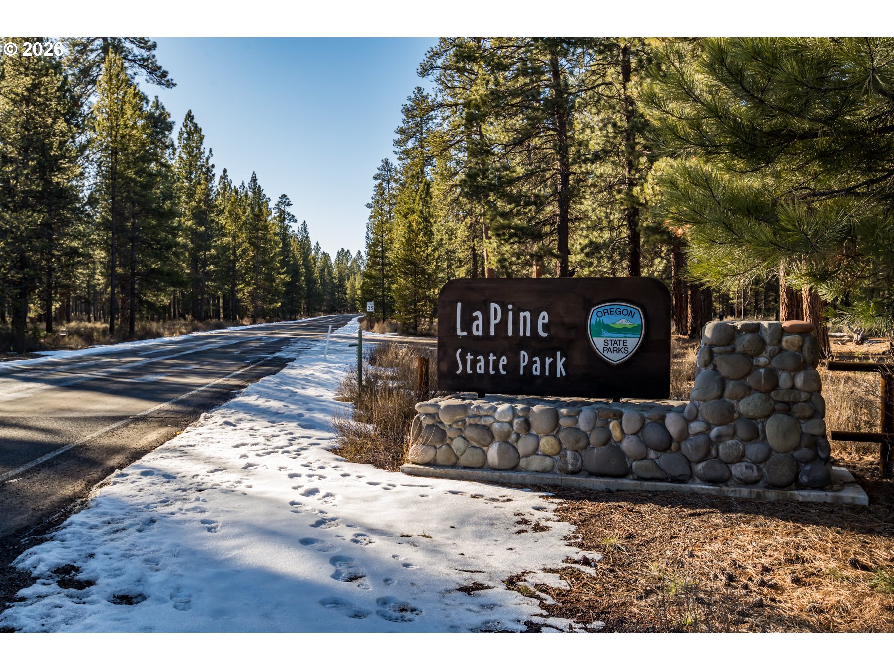 15490 Rainbow Court La Pine, OR 97739 - Photo 13 of 14 a view of a wooden fence and a sign board