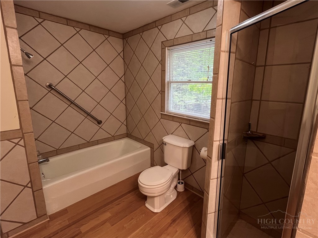 638 Ridge Road Glade Valley, NC 28627 - Photo 36 of 44 a bathroom with a toilet a sink and a bathtub