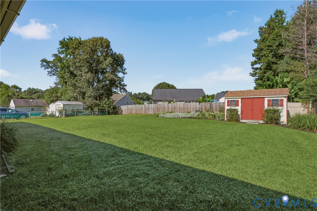 5210 Ronson Road North Chesterfield, VA 23234 - Photo 30 of 35 Expansive grassy yard with a wooden privacy fence,