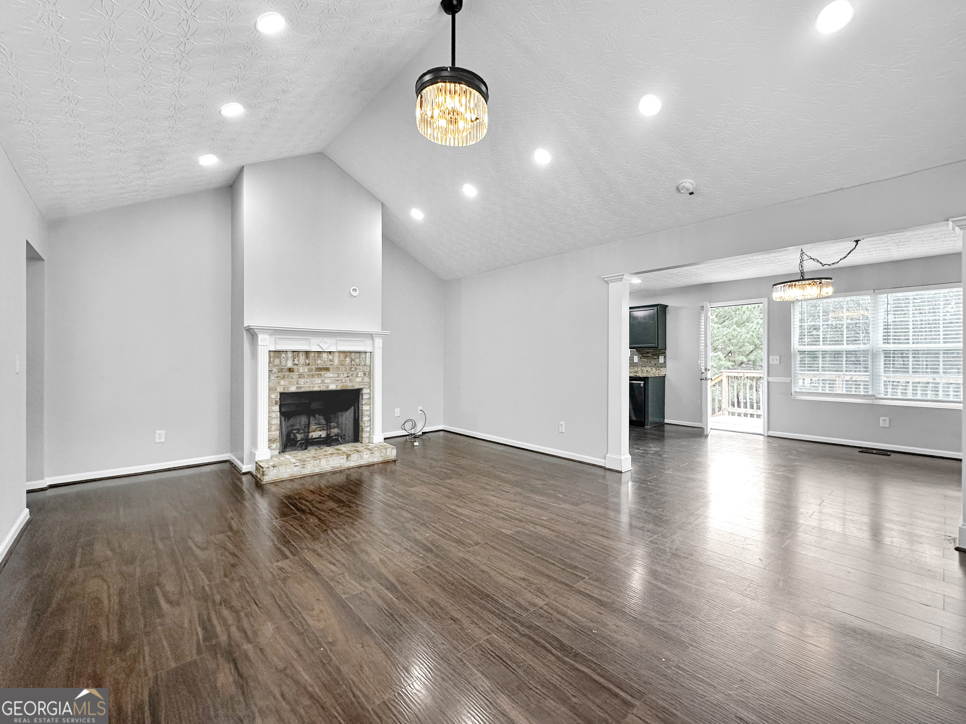 105 Aprils Way Union City, GA 30291 - Photo 4 of 20 an empty room with wooden floor and fireplace