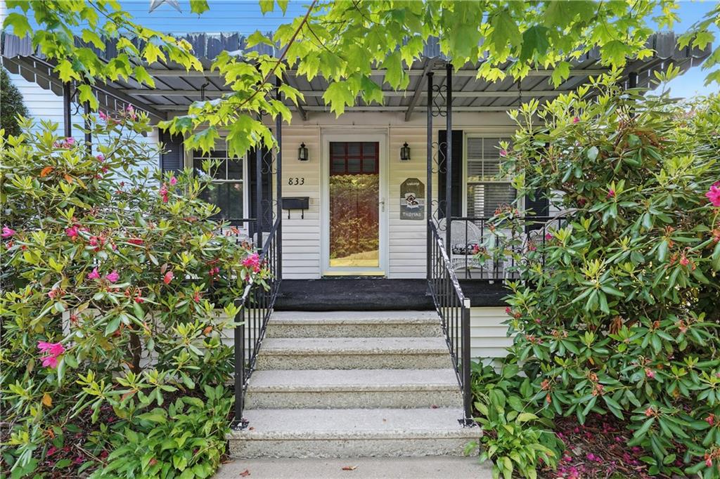 a view of a house with potted plants