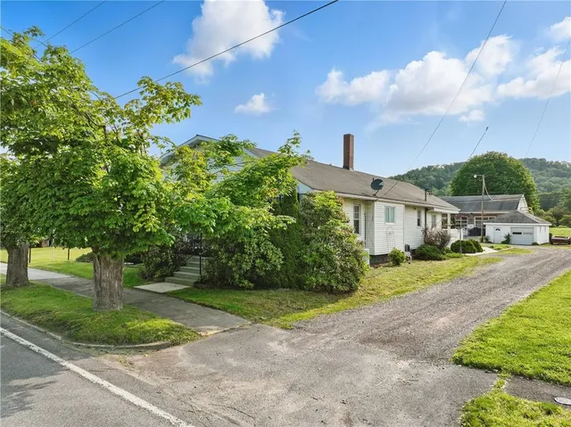 a front view of a house with a yard and a garden