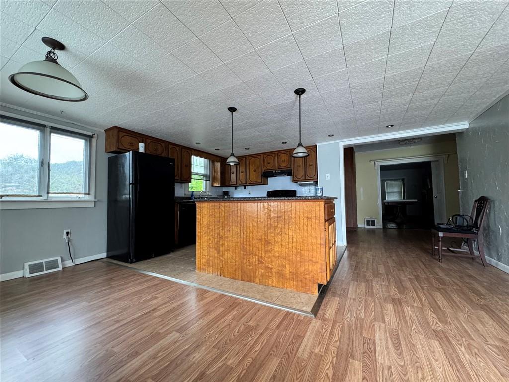 833 Oden Street Confluence, PA 15424 - Photo 21 of 48 a view of a kitchen with wooden floor and a refrigerator