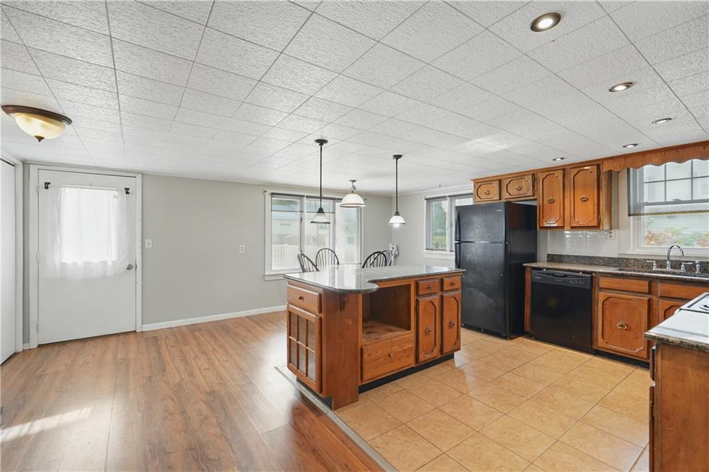 833 Oden Street Confluence, PA 15424 - Photo 22 of 48 a kitchen with stainless steel appliances granite countertop a stove a refrigerator a sink dishwasher and wooden cabinets with wooden floor