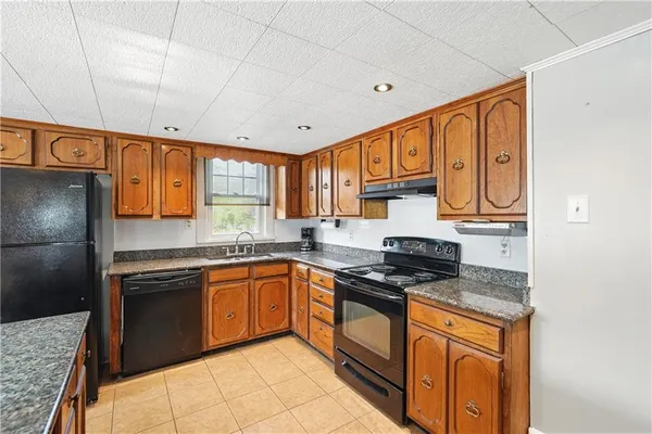 a kitchen with stainless steel appliances granite countertop a stove sink and cabinets