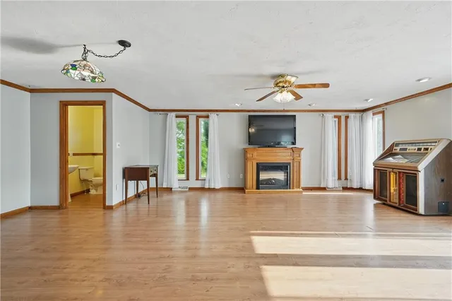 a view of an empty room with a fireplace and a window