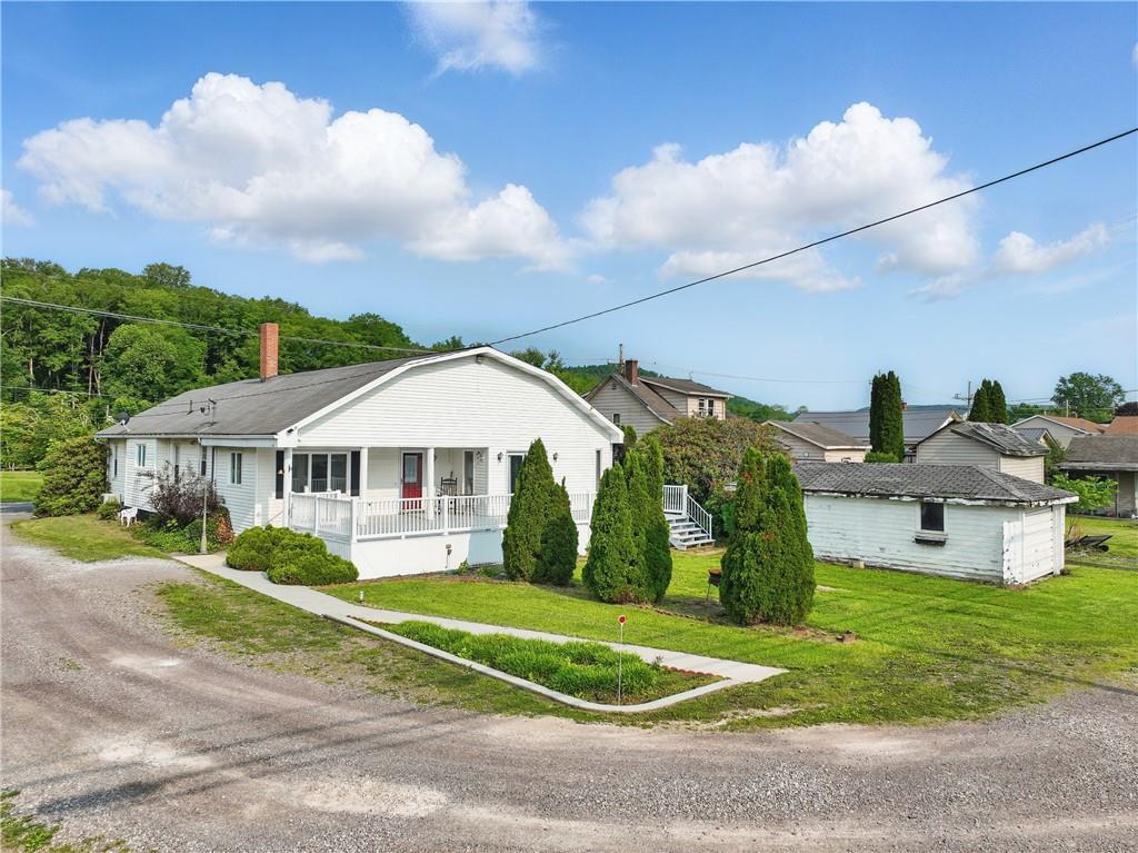 833 Oden Street Confluence, PA 15424 - Photo 3 of 48 a front view of a house with a yard and potted plants