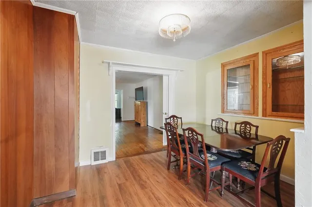 a view of a dining room with furniture and chandelier