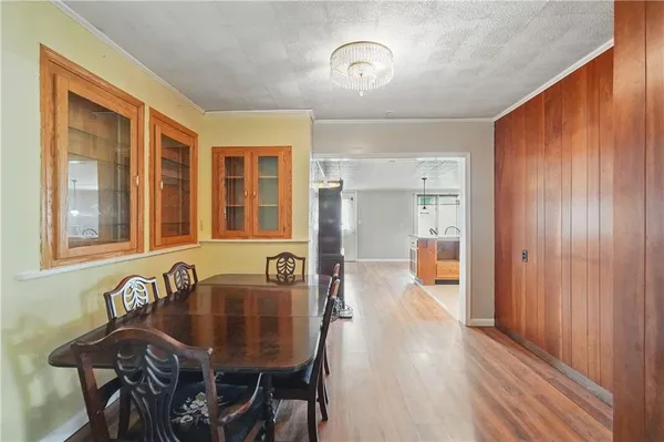 a dining room with furniture and wooden floor
