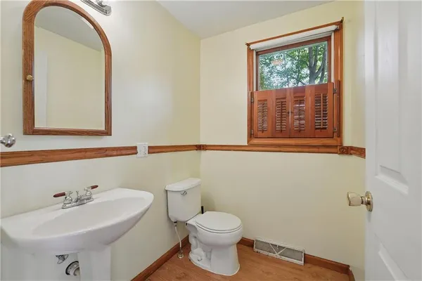 a bathroom with a sink a mirror and a toilet