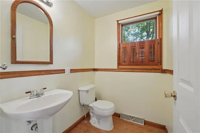 a bathroom with a sink a mirror and a toilet