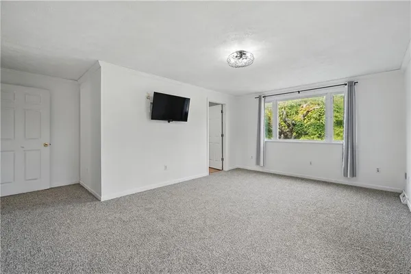 a view of room with window and flat screen tv