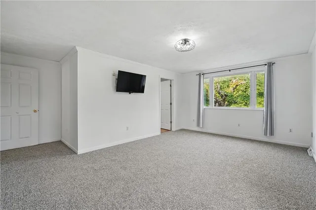 a view of room with window and flat screen tv