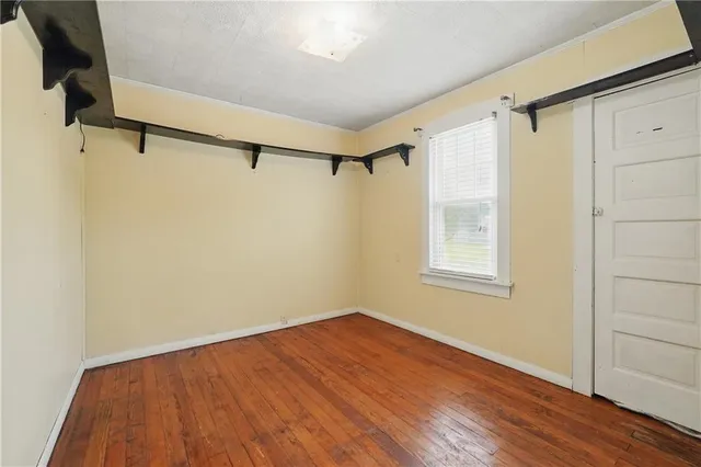 a view of a room with wooden floor and brick walls