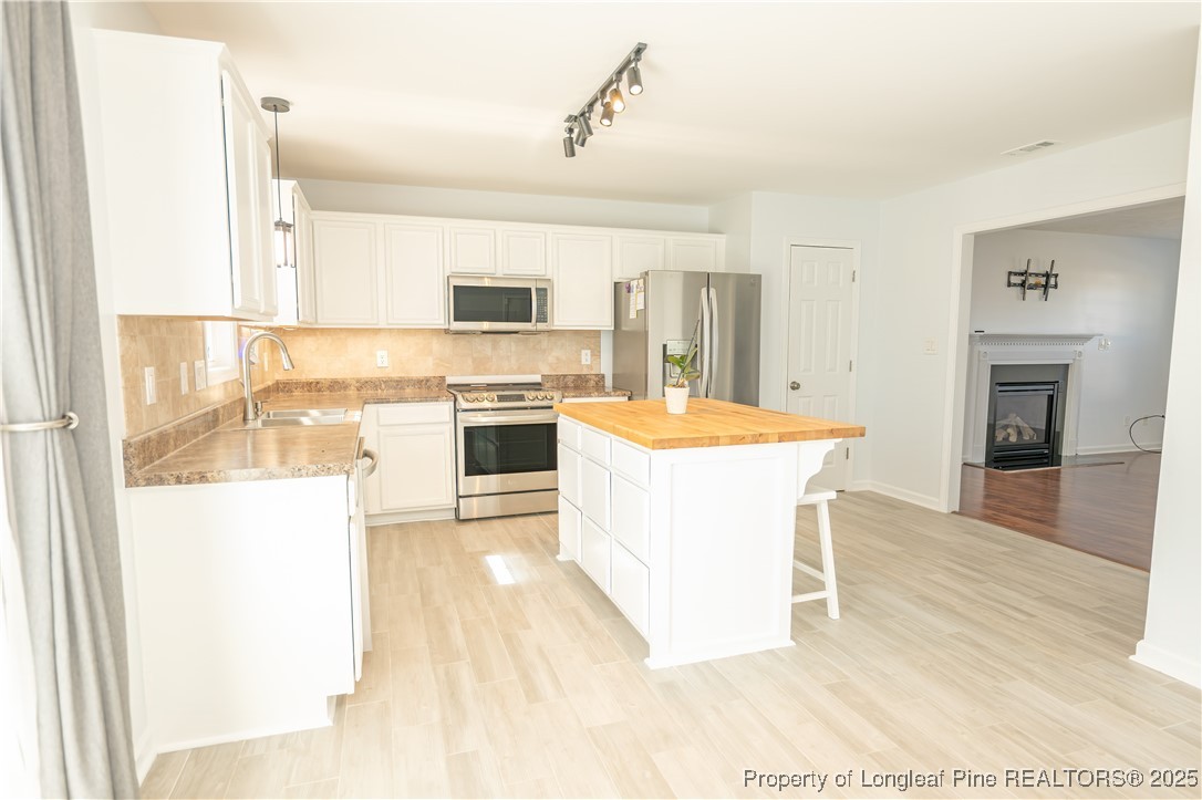 2112 Yellowbrick Road Fayetteville, NC 28314 - Photo 11 of 48 a kitchen with a sink stove and refrigerator