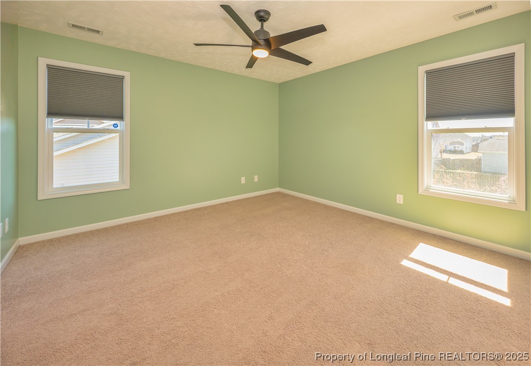 2112 Yellowbrick Road Fayetteville, NC 28314 - Photo 21 of 48 an empty room with a window and a ceiling fan