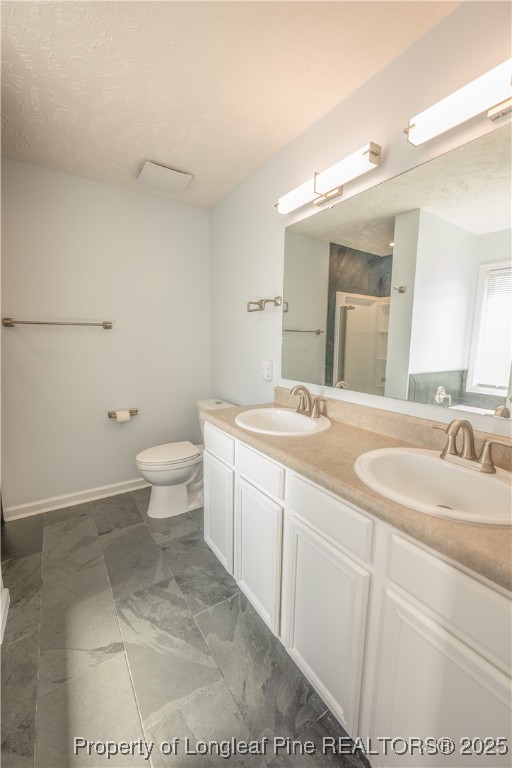 2112 Yellowbrick Road Fayetteville, NC 28314 - Photo 24 of 48 a bathroom with a toilet sink and mirror