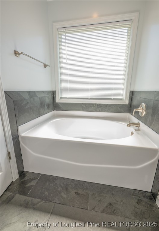 2112 Yellowbrick Road Fayetteville, NC 28314 - Photo 26 of 48 a bathroom with a bathtub and a shower