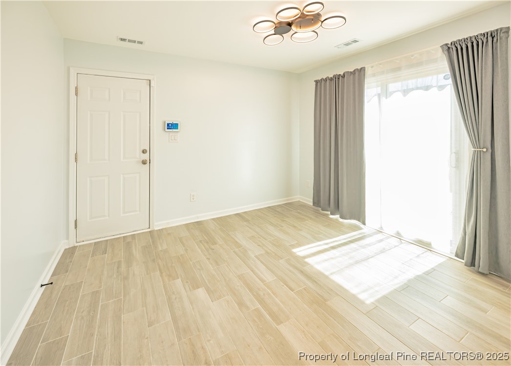 2112 Yellowbrick Road Fayetteville, NC 28314 - Photo 38 of 48 a view of a room with wooden floor and ceiling fan