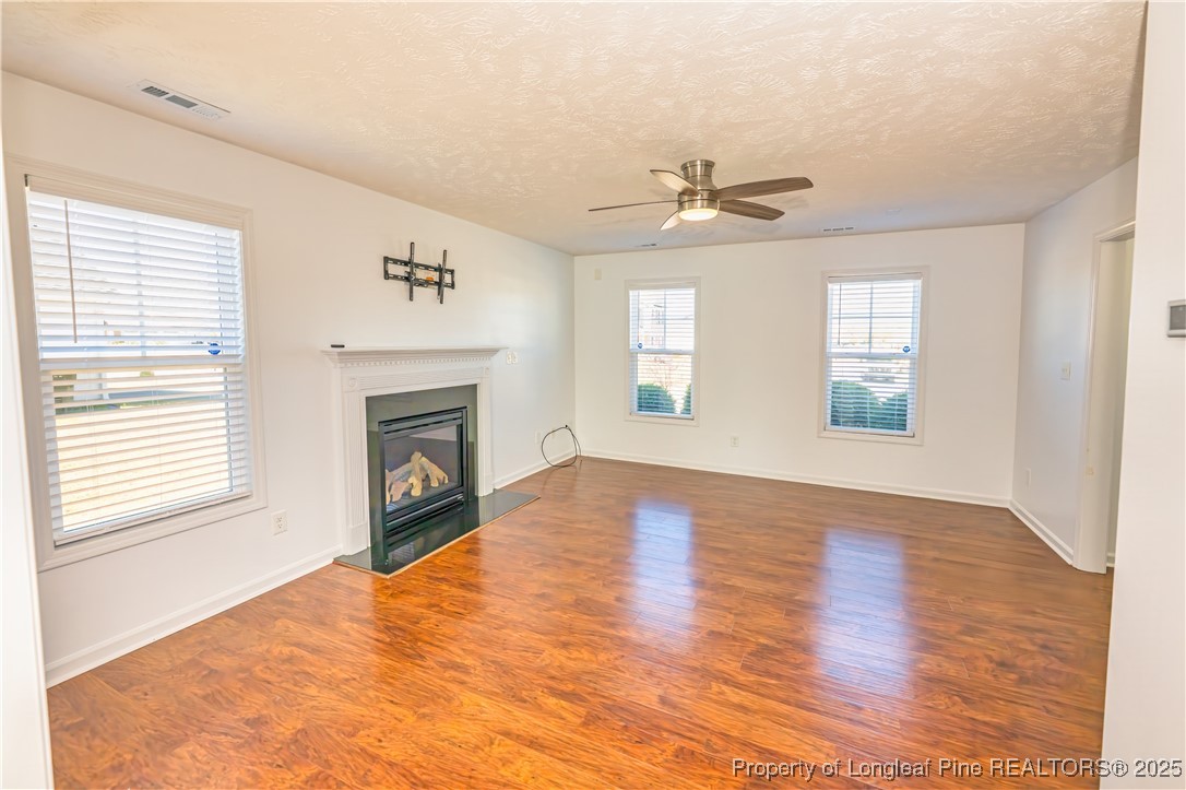 2112 Yellowbrick Road Fayetteville, NC 28314 - Photo 5 of 48 a view of empty room with a fireplace and wooden floor