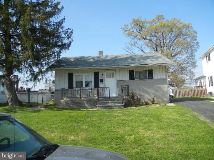 1832 Kitty Hawk Road Essex, MD 21221 - Photo 1 of 2 a front view of house with yard outdoor seating and green space
