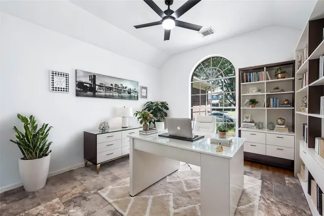 a living room with furniture a fireplace and a large window