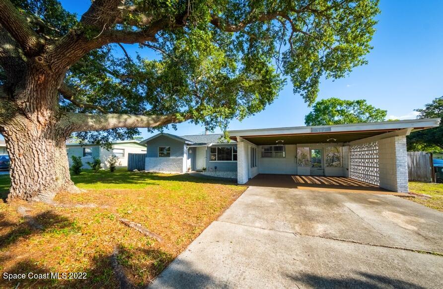 982 Cardon Drive Rockledge, FL 32955 - Photo 1 of 27 a front view of a house with a yard and garage