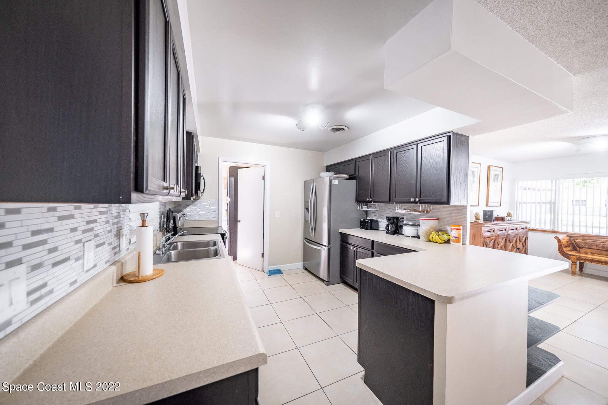 982 Cardon Drive Rockledge, FL 32955 - Photo 13 of 27 a kitchen with a sink appliances and cabinets