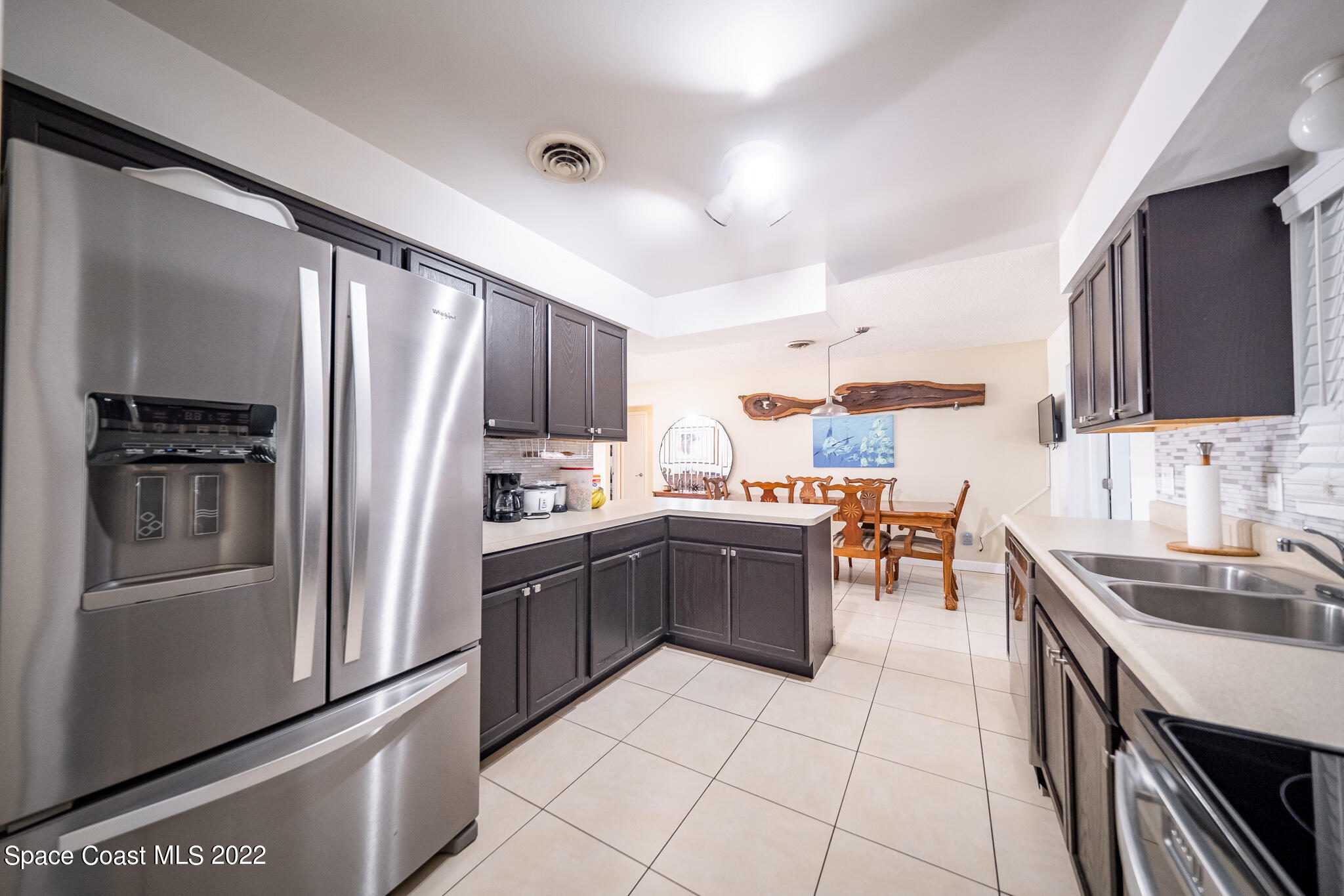 982 Cardon Drive Rockledge, FL 32955 - Photo 15 of 27 a kitchen with granite countertop a refrigerator stove top oven and sink