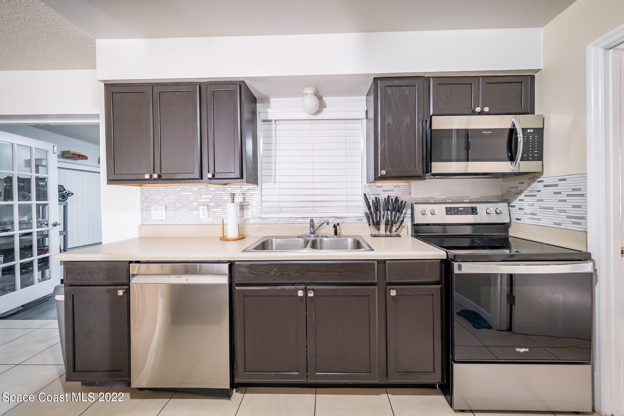 982 Cardon Drive Rockledge, FL 32955 - Photo 16 of 27 a kitchen with stainless steel appliances granite countertop a stove and a sink