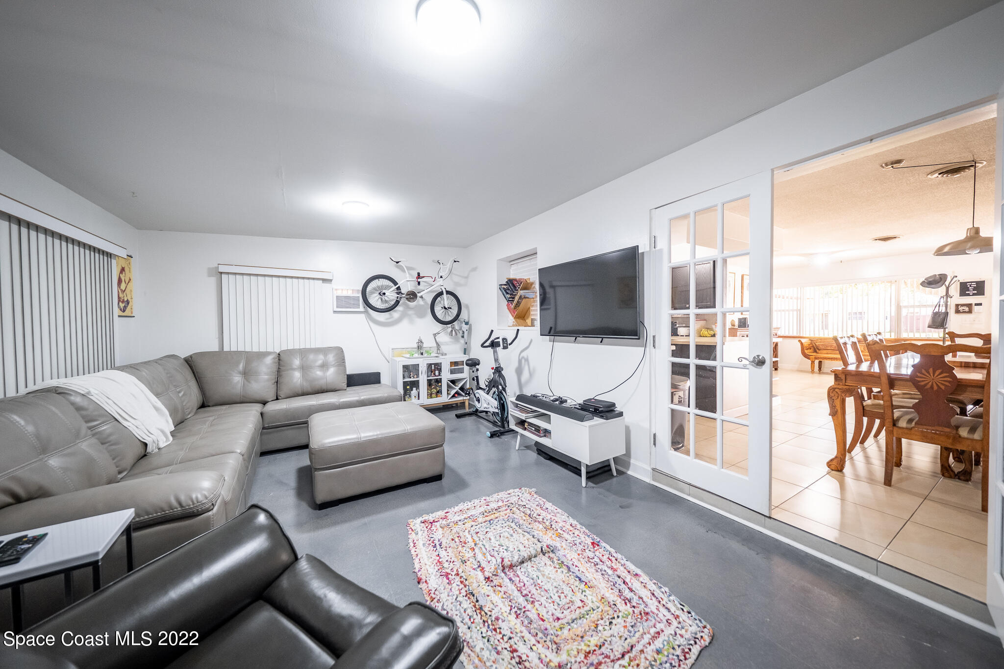 982 Cardon Drive Rockledge, FL 32955 - Photo 19 of 27 a living room with furniture and a flat screen tv