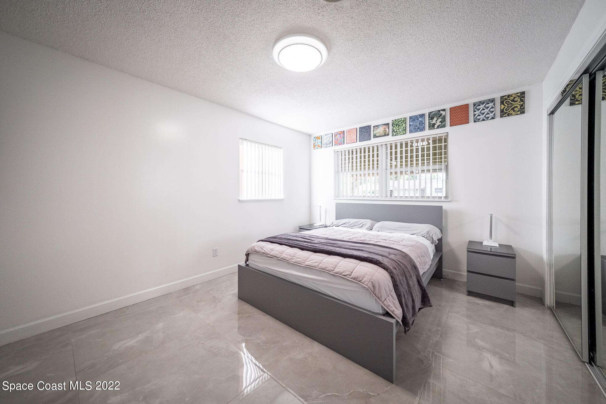 982 Cardon Drive Rockledge, FL 32955 - Photo 20 of 27 a spacious bedroom with a bed and a window