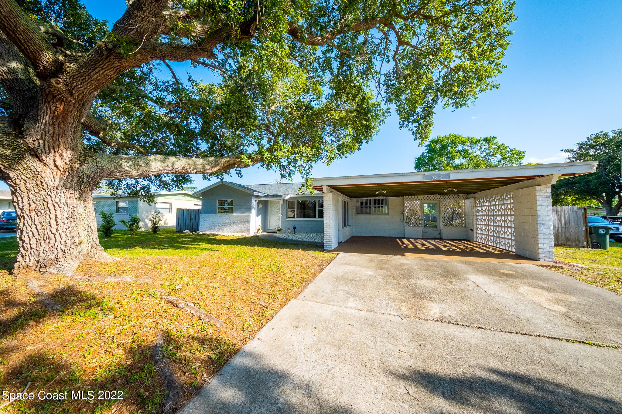 982 Cardon Drive Rockledge, FL 32955 - Photo 2 of 27 a front view of a house with a yard garage and outdoor seating