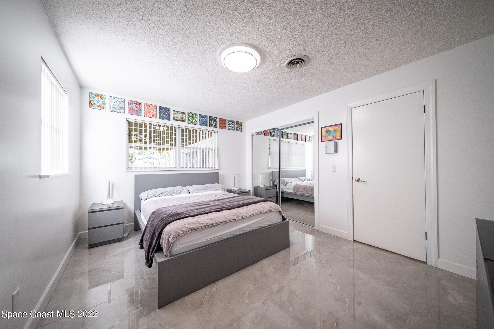 982 Cardon Drive Rockledge, FL 32955 - Photo 21 of 27 a bedroom with a bed and a window