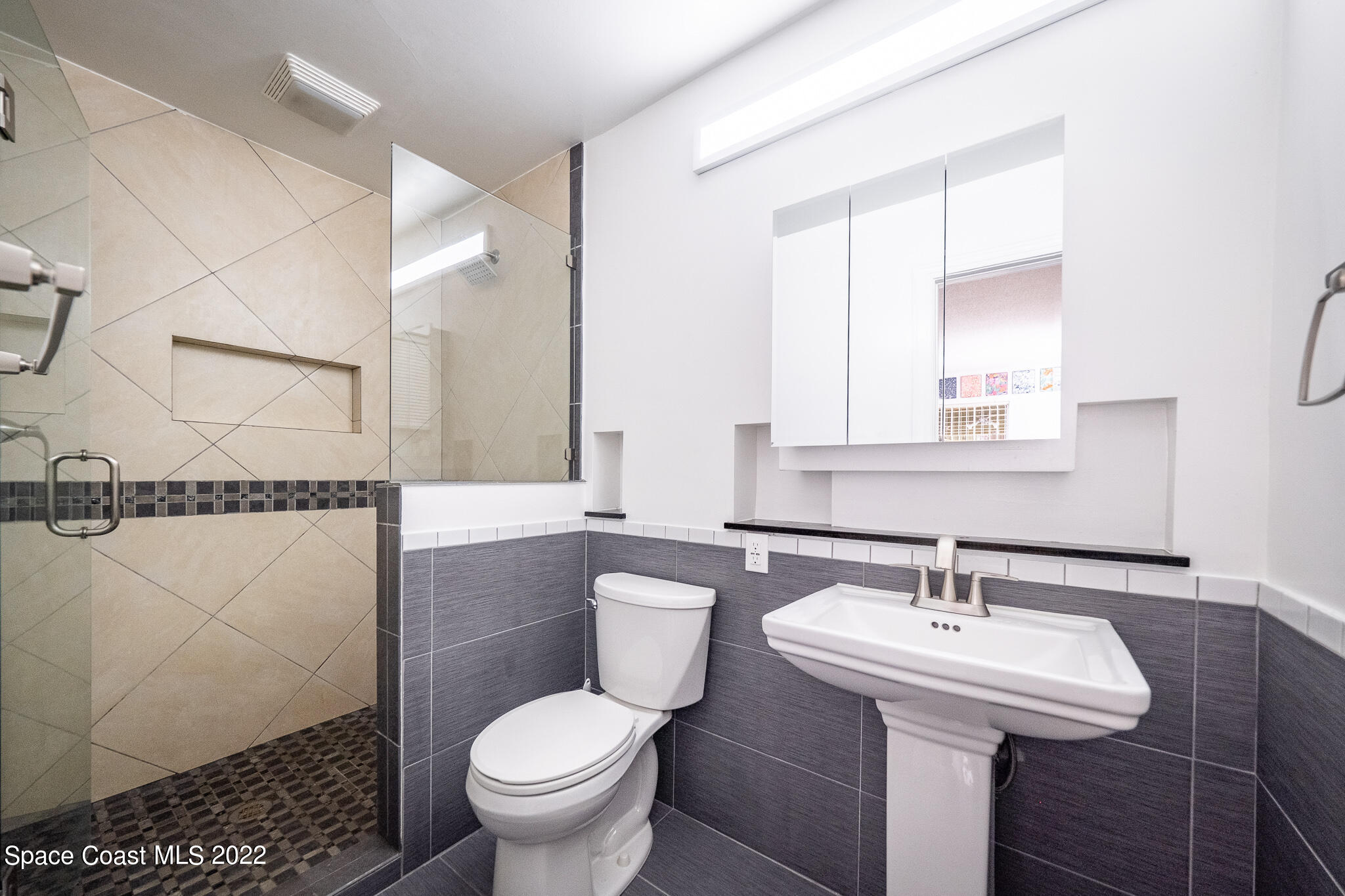 982 Cardon Drive Rockledge, FL 32955 - Photo 23 of 27 a bathroom with a sink toilet and a mirror
