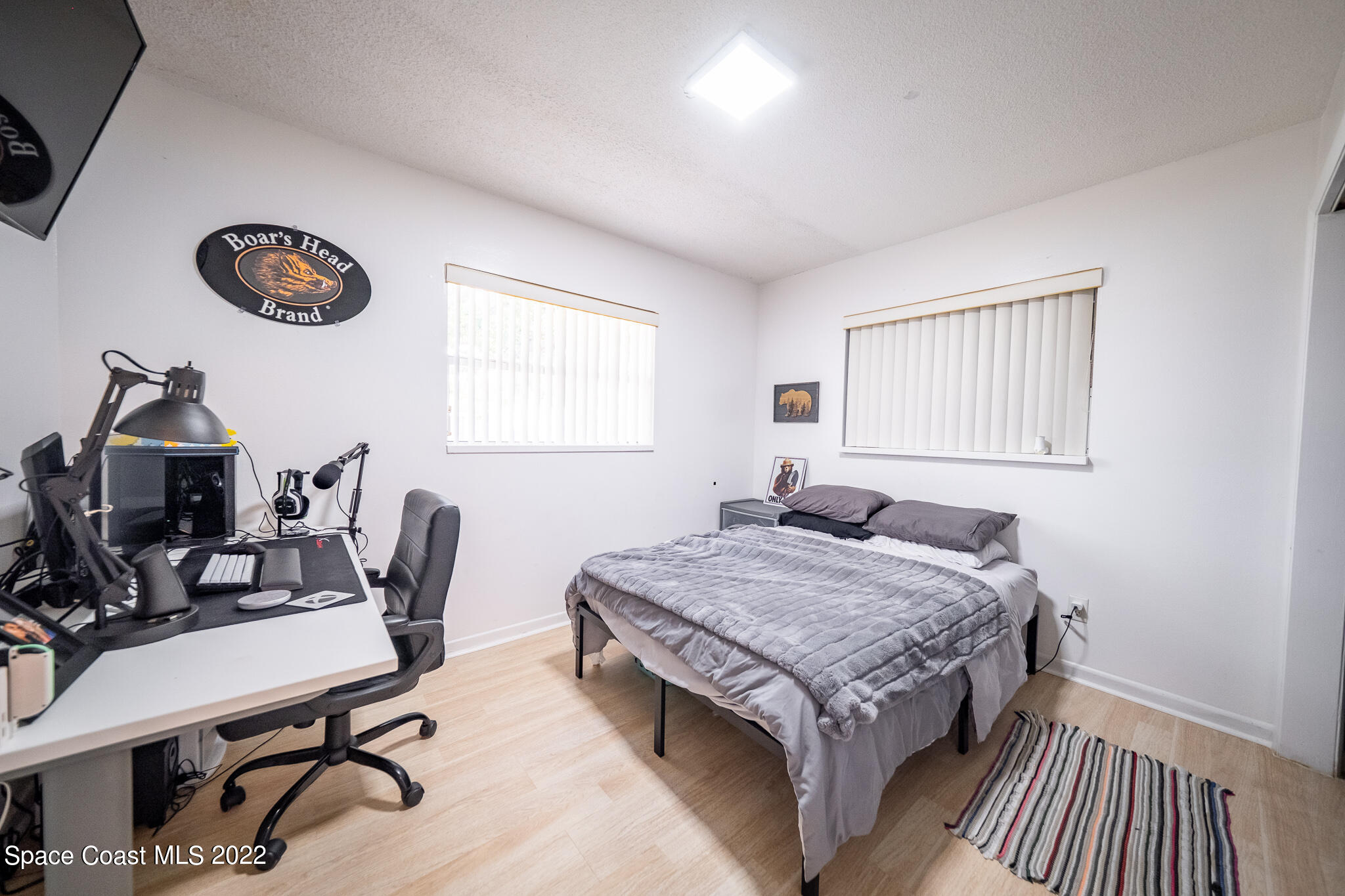 982 Cardon Drive Rockledge, FL 32955 - Photo 24 of 27 a bedroom with a bed and a desk