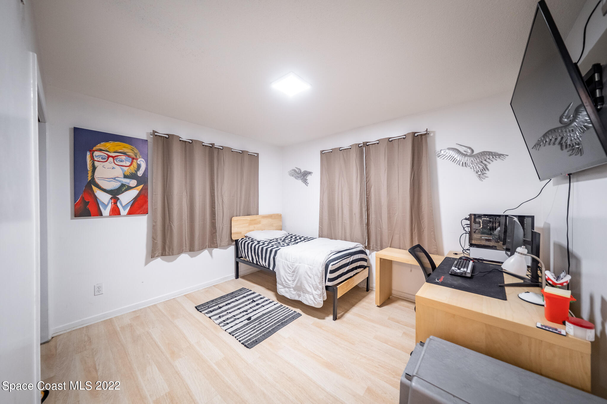 982 Cardon Drive Rockledge, FL 32955 - Photo 26 of 27 a bedroom with furniture and a chandelier