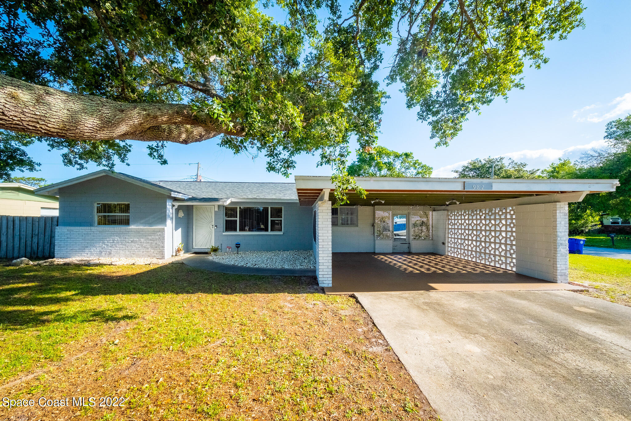 982 Cardon Drive Rockledge, FL 32955 - Photo 3 of 27 a front view of a house with a yard and garage