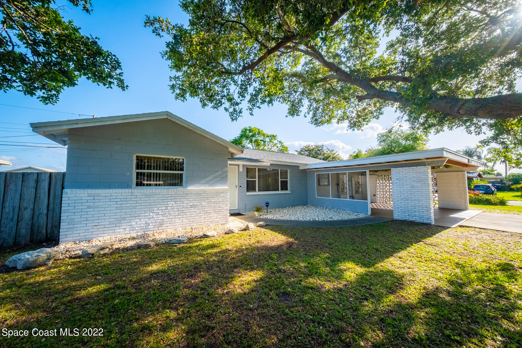 982 Cardon Drive Rockledge, FL 32955 - Photo 4 of 27 a front view of house with yard and trees in the background